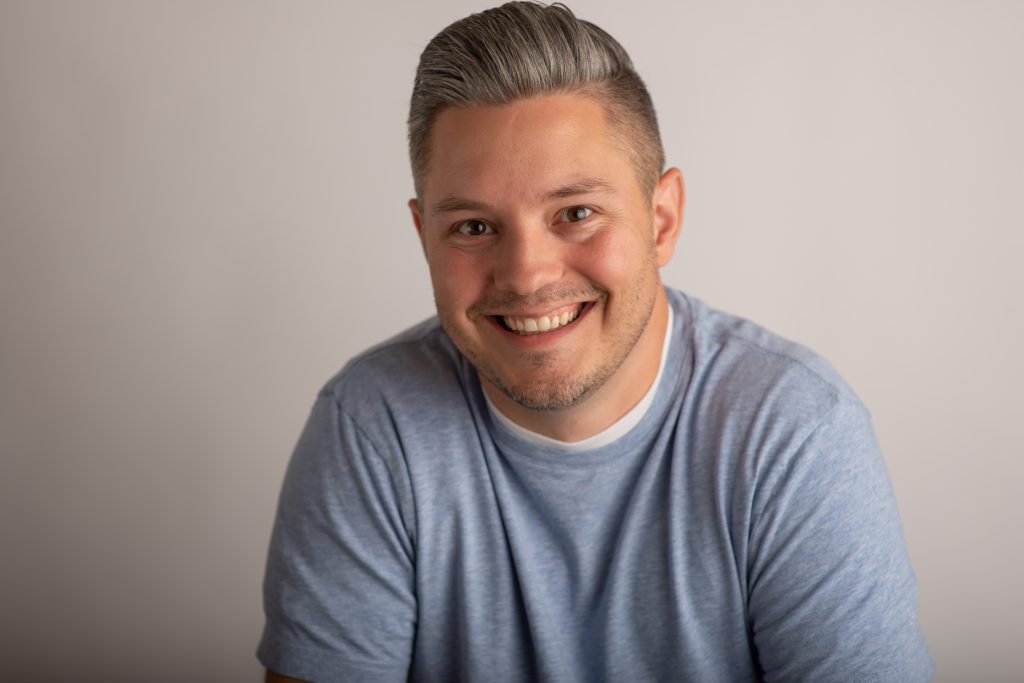 Smiling man in casual attire.
