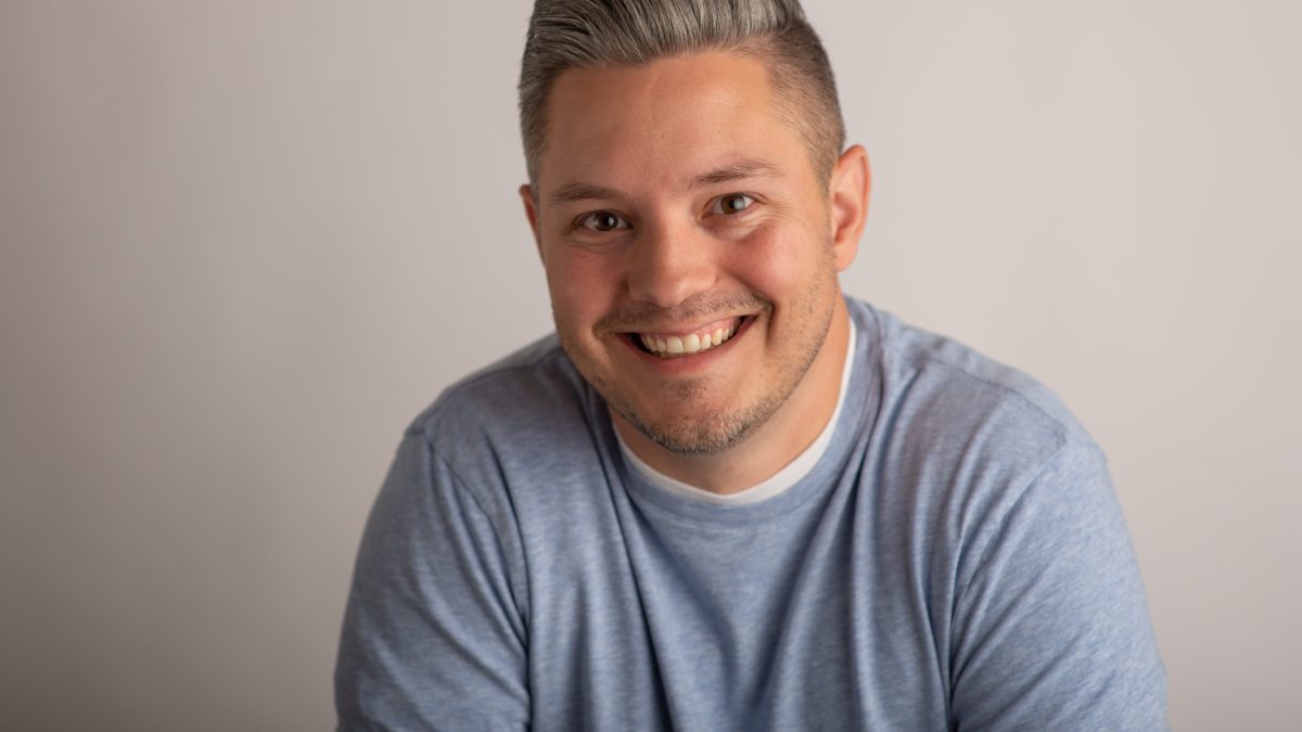 Smiling man in casual attire.