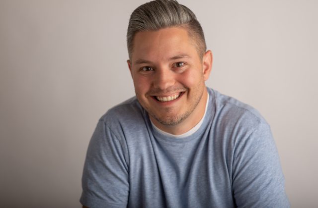 Smiling man in casual attire.